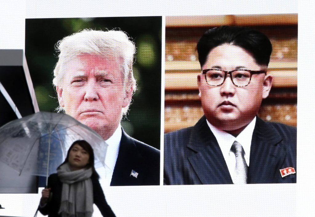 United States North Korea What’s Ahead A woman walks by a huge screen showing U.S. President Donald Trump, left, and North Korea's leader Kim Jong Un, in Tokyo, Friday, March 9, 2018. (Koji Sasahara/AP Photo)