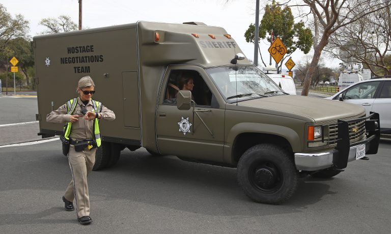 A sheriff's hostage negotiation team passes a California highway patrol checkpoint at the Veterans Home of California in Yountville, Calif., Friday, March 9, 2018. Napa County Fire Capt. Chase Beckman says a gunman has taken hostages at the veterans home. Police closed access to the large veterans home after a man with a gun was reported on the grounds. (Ben Margot/AP Photo)