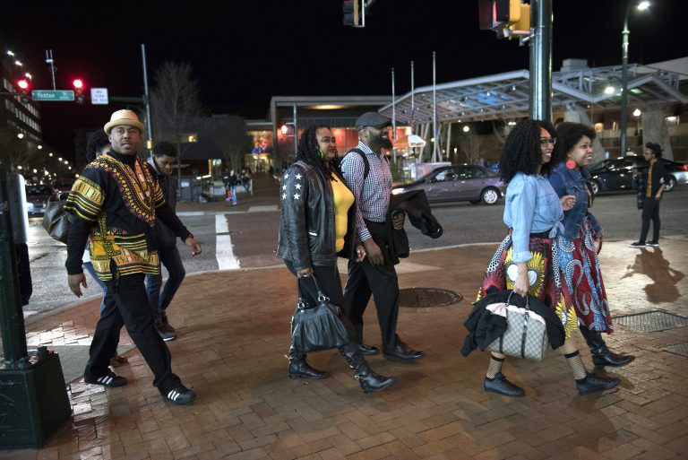 In this Feb. 15, 2018, file photo, Emanuel Lawton, (left), and his family dressed in Wakanda-inspired attire arrive to see Black Panther in Silver Spring, Md. Featuring a predominantly black cast, the film that is an ode to Africa - with costuming and sets heavily inspired by African cultures - moved many viewers, including cast members themselves, to dress in African-themed garments for their viewing the film. (Sait Serkan Gurbuz/AP Photo, File)