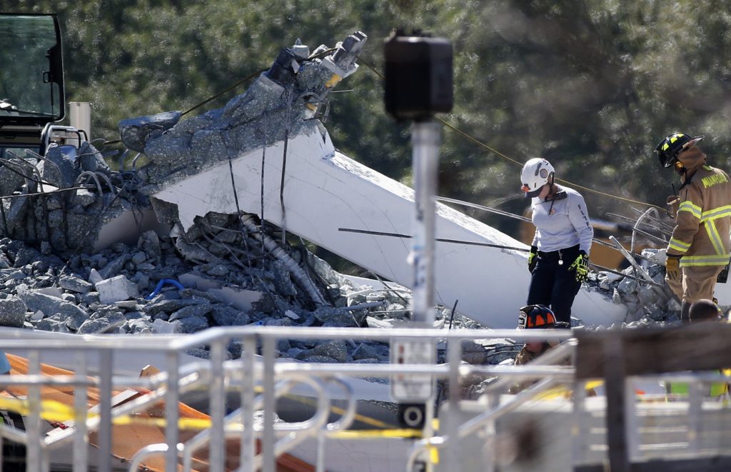University Bridge Collapse Rescue workers walk on the rubble after a brand-new pedestrian bridge collapsed at Florida International University in Miami on Thursday, March 15, 2018. The pedestrian bridge collapsed onto a highway crushing multiple vehicles and killing several people. (Wilfredo Lee/AP Photo)