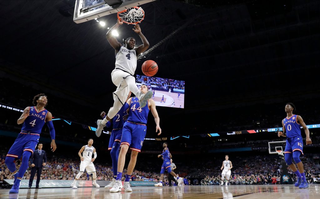 Final Four Kansas Villanova Basketball Villanova's Eric Paschall (4) dunks over Kansas's Mitch Lightfoot (44) during the second half in the semifinals of the Final Four NCAA college basketball tournament, Saturday, March 31, 2018, in San Antonio. (AP Photo/David J. Phillip)