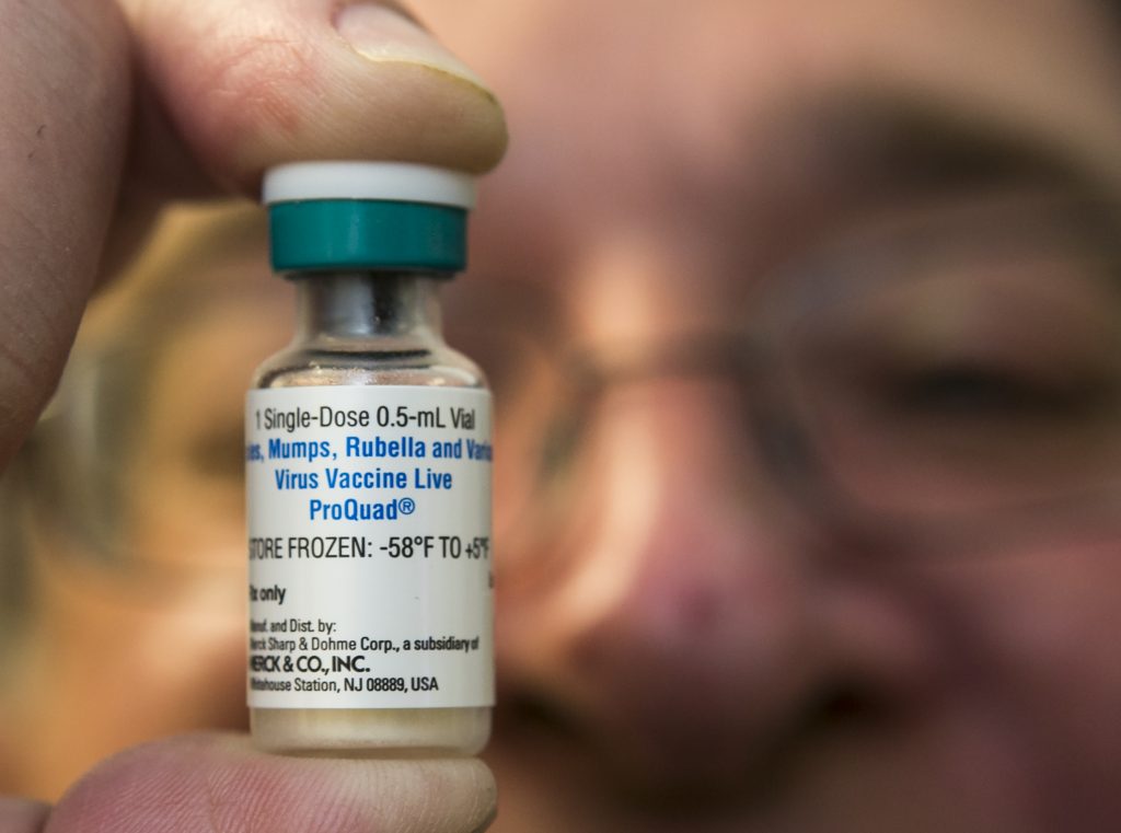 Charles Goodman A pediatrician holds up a measles
