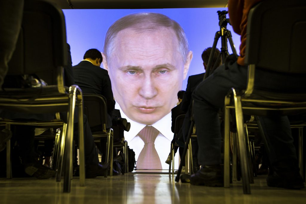 Vladimir Putin Journalists watch as Russian President Vladimir Putin gives his annual state of the nation address in Manezh in Moscow, Russia, Thursday, March 1, 2018. (Alexander Zemlianichenko/AP Photo)