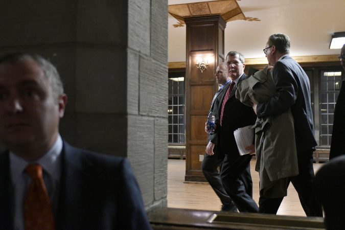 Temple University's President Richard M. Englert departs after cutting short a presentation for the proposed $130 million, 35,000 seat stadium on Temple's campus, at a town hall meeting on Tuesday. (Bastiaan Slabbers/for WHYY)