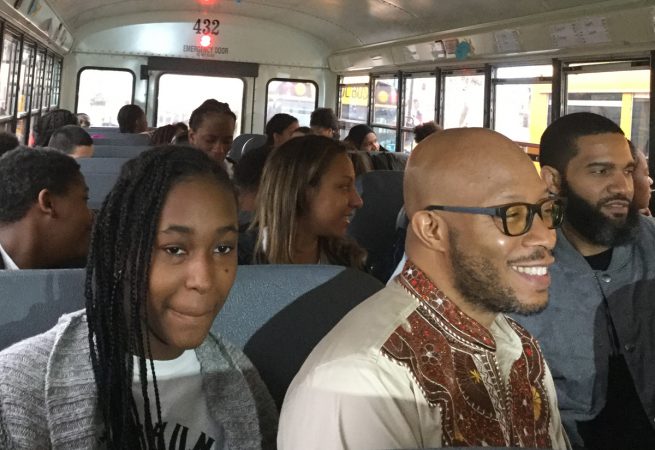 Seventh-grader Daiyannah Brown and Mr. Douglas are all smiles while on their way to see Black Panther. (Kyrie Greenberg/for WHYY)
