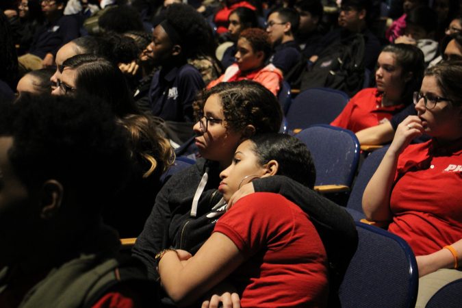Pennsauken High School students listen as the names of the Parkland school shooting victims are read during an assembly in the school auditorium.