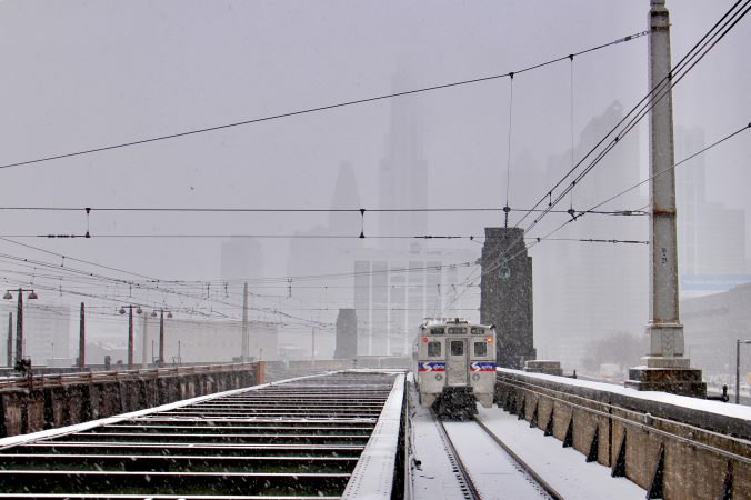 A regional rail train departs 30th Street Station as the snow intensifies.