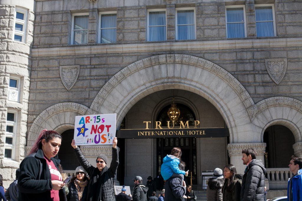 March_For_Our_Lives_DC-17 Demonstrators pass by the Trump International Hotel in downtown Washington D.C. Saturday afternoon during the March for Our Lives. (Brad Larrison for WHYY)