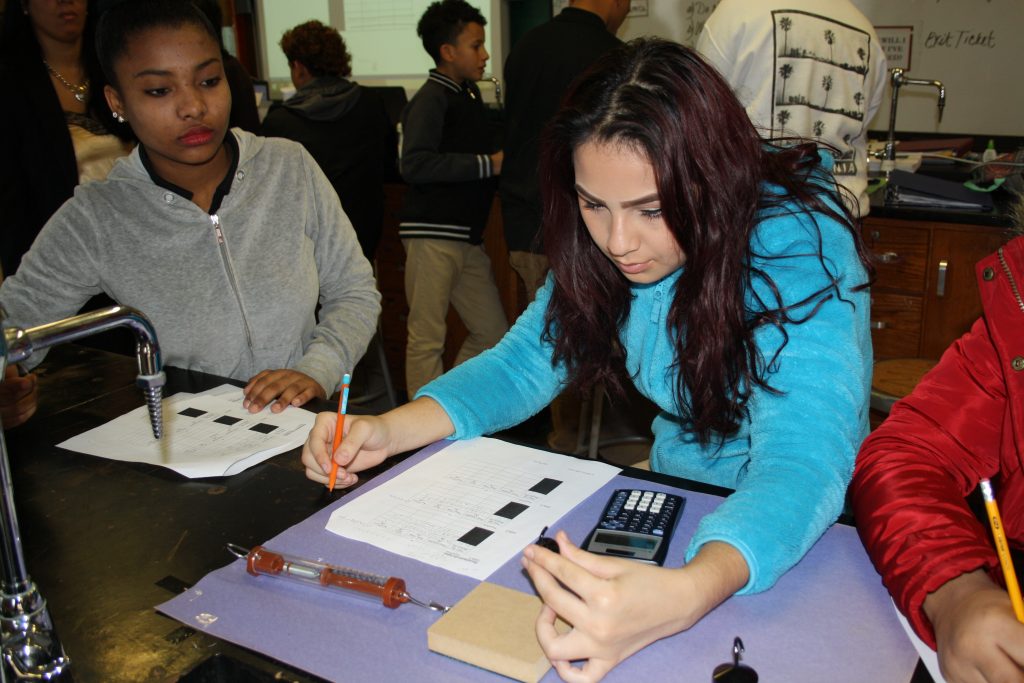 Tara Garcia Mathewson – STEMphysics1 Maria Ramirez, left, and Eunice Millán, both freshmen at Woodrow Wilson High School in Camden, New Jersey, are taking physics this year as part of a “Physics First” initiative to prepare more students for STEM careers. (Tara García Mathewson/The Hechinger Report)