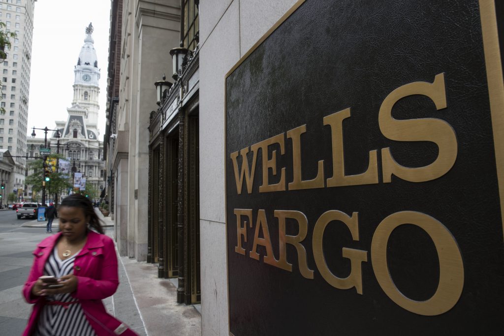 Philadelphia Wells Fargo A woman walks past a Wells Fargo location in view of City Hall, left, in Philadelphia, Thursday, May 11, 2017.