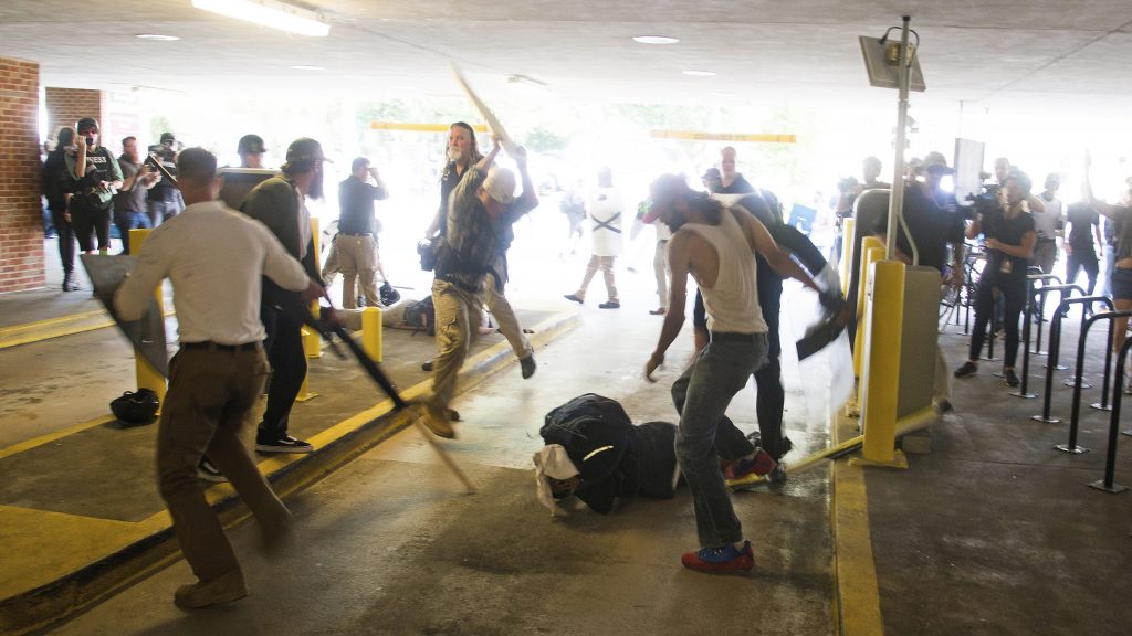 DeAndre Harris, seen balled on the ground, suffers a beating in a parking garage near the Charlottesville police station after the white nationalist rally last August. DeAndre Harris, seen balled on the ground, suffers a beating in a parking garage near the Charlottesville police station after the white nationalist rally last August. Zach D. Roberts/AP