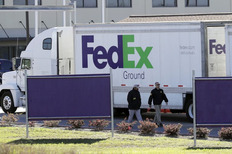 Bureau of Alcohol, Tobacco, Firearms and Explosives agents investigate the scene at a FedEx distribution center where a package exploded on Tuesday, in Schertz, Texas. Authorities believe the package bomb is linked to the recent string of Austin bombings.