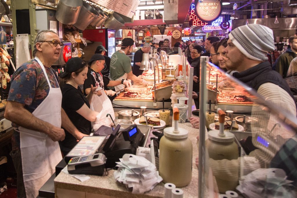 cohen-hershels_east_side_deli-23 Hershel's East Side Deli chef and co-owner Andy Wash (left) and his crew tend to customers. With a seemingly endless line, it is all hands on deck with each worker prepping different orders.