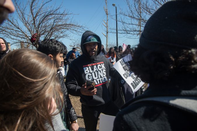 An anti-gun control activist tries to convince some of the marchers the reasons he believes gun control is not the way to curb gun violence during the 
Philadelphia March for Our Lives, March 24, 2018. (Emily Cohen for WHYY)