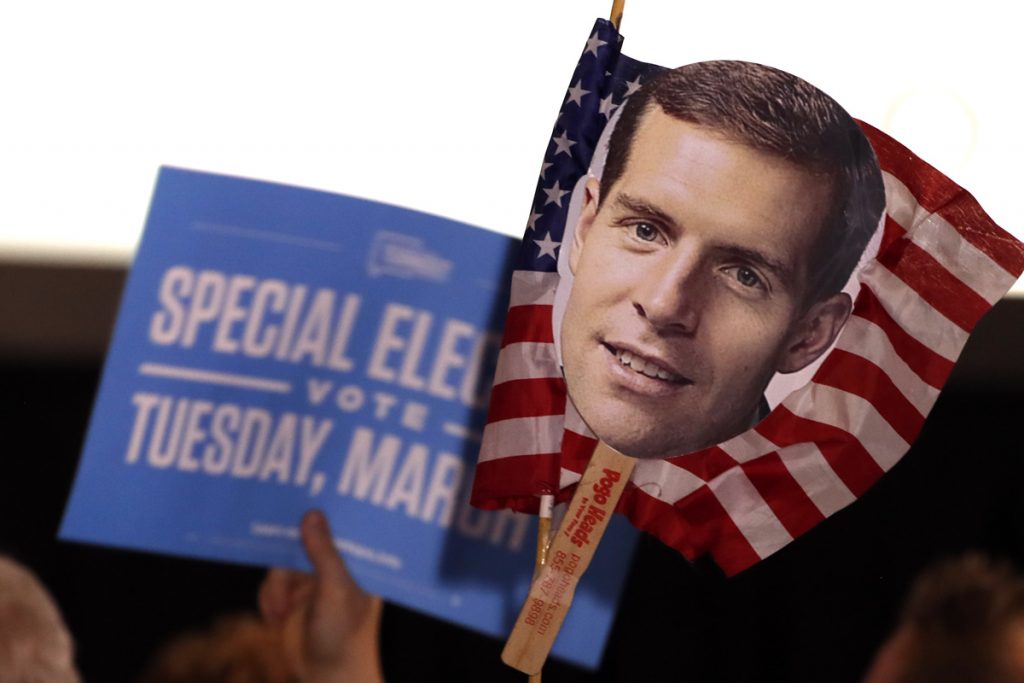Conor Lamb Supporters of Conor Lamb hold signs during his election night party