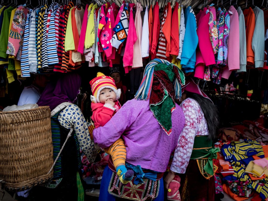 gettyimages-626326492-61ab9c76ea601bb5a49f2efd5927ee4181d73277-s1600-c85 Shoppers explore the goods on display in Ha Giang, Vietnam. The country's textile industry was expected to be one of the biggest winners from the Trans-Pacific Partnership, which would have provided tariff-free access to U.S. markets. Under the new agreement, the industry is still expected to gain — if not nearly as much. (Linh Pham/Getty Images)