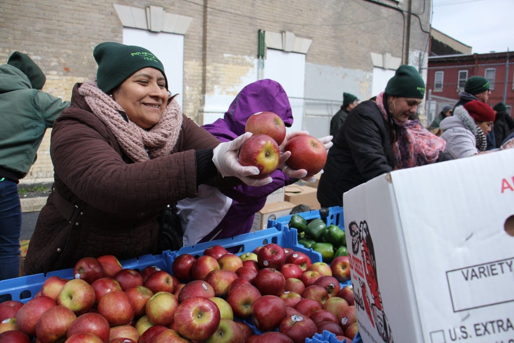 lead 2018 03 14-e lee-philadelphia lillian marrero library-philabundance free farmers market Volunteers fill bags and boxes with fresh produce during the Philabundance free farmers market at Lillian Marrero Library.