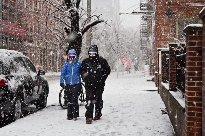 Pedestrian trudge through the storm in Philadelphia Wednesday afternoon. (Kimberly Paynter/WHYY)