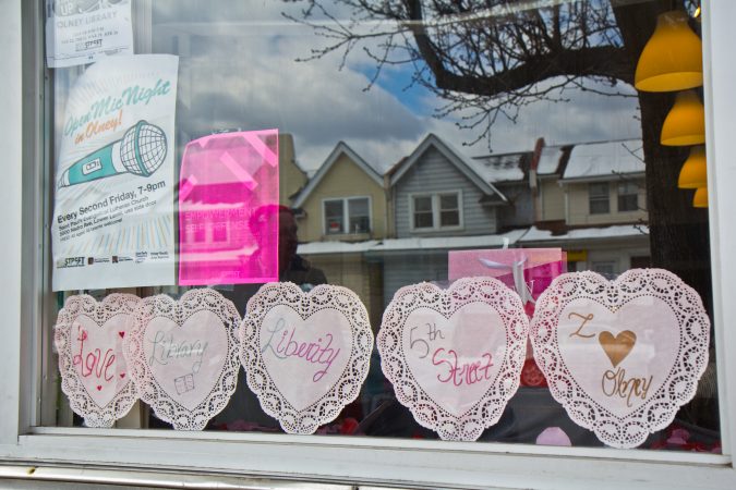 The window of the North 5th Street Revitalization Project office shows love for the neighborhood and advertises their monthly open mic.