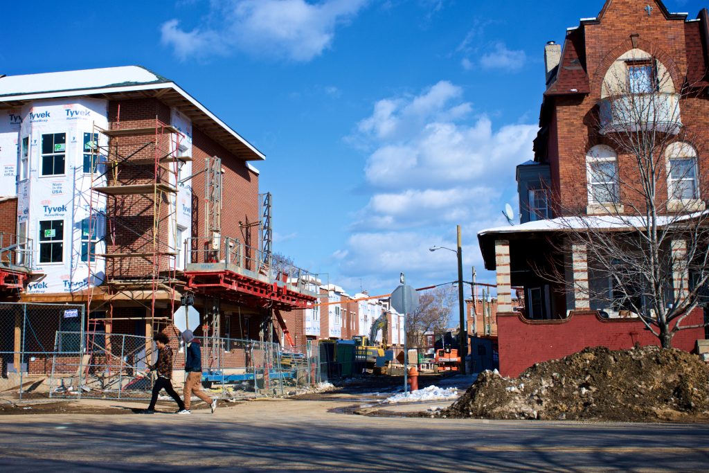 Strawberry Mansion Neighborhood, in Philadelphia, PA Two young men walk past a rehab project in Strawberry Mansion, in 2018.