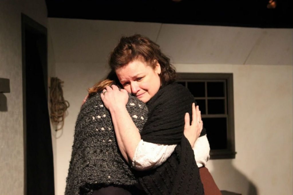 111 Mary Pat Walsh (shown) gives a hug to Katie Stahl in the Irish Heritage Theatre production of