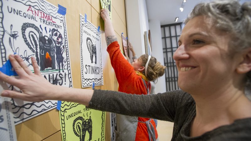 MFA students and musem staff members, covered the closed doors to the Chuck Close Exhibit with protest posters. (Jonathan Wilson for WHYY)