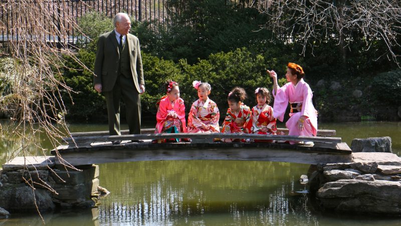 Joseph Zuritsky (left) who donated his prized koi fish to the Shofuso Japanese House and Garden in Fairmount Park, participates in a Cherry Blossom Festival event with students from the Japanese Language School of Philadelphia. (Emma Lee/WHYY)