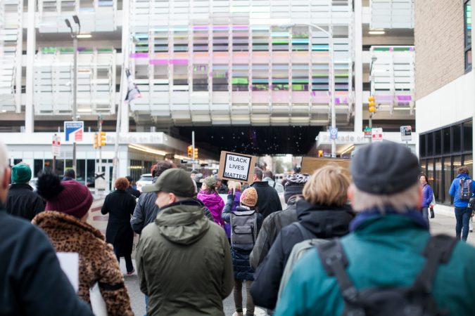 Demonstrators march  toward City Hall in response to an incident last week where two black men were arrested in a Center City Starbucks. (Brad Larrison for WHYY)