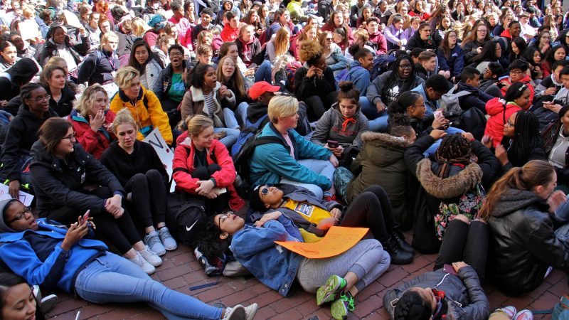 High school students lie down in the City Hall courtyard for a die-in, part of a national day of protest against gun violence on the 19th anniversary of the Columbine school shooting. (Emma Lee/WHYY)