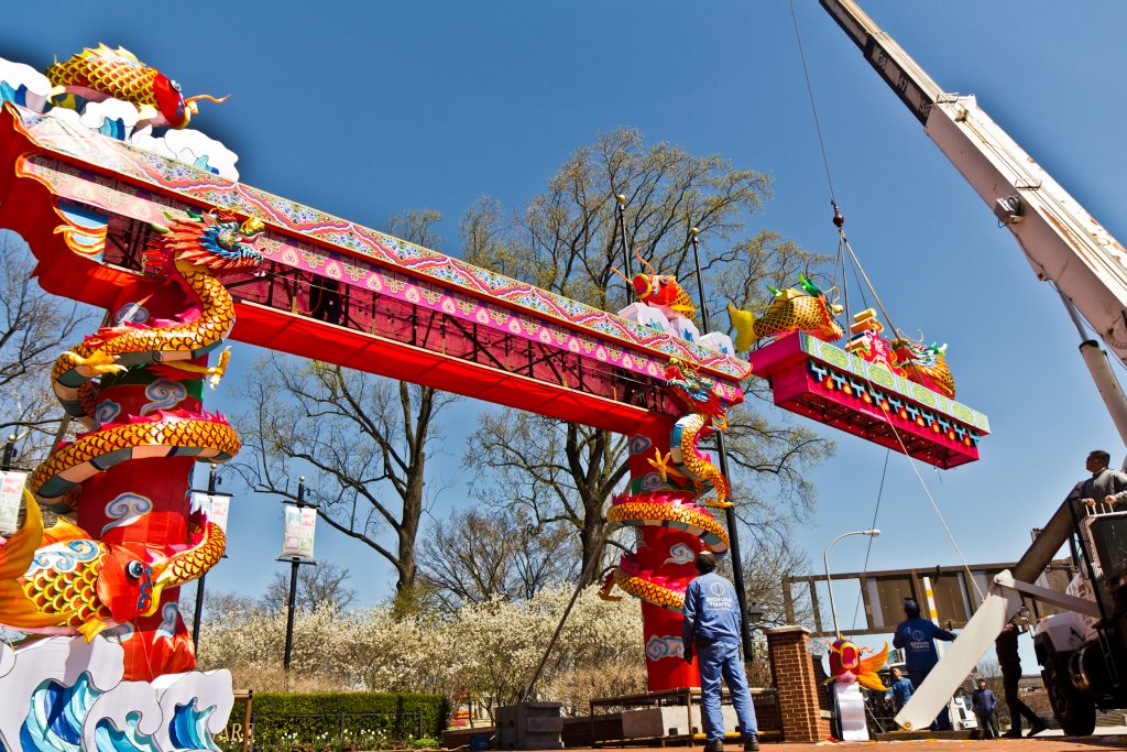 The top of the entryway arch is lifted by crane Friday afternoon. (Kimberly Paynter/WHYY)