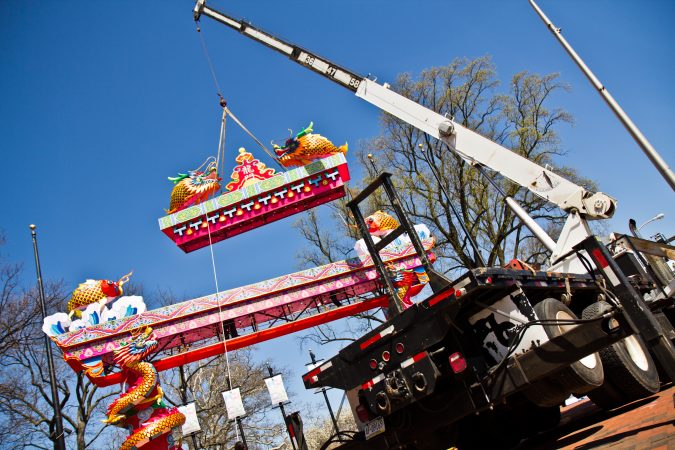 The top of the entryway arch is lifted by crane Friday afternoon. (Kimberly Paynter/WHYY)