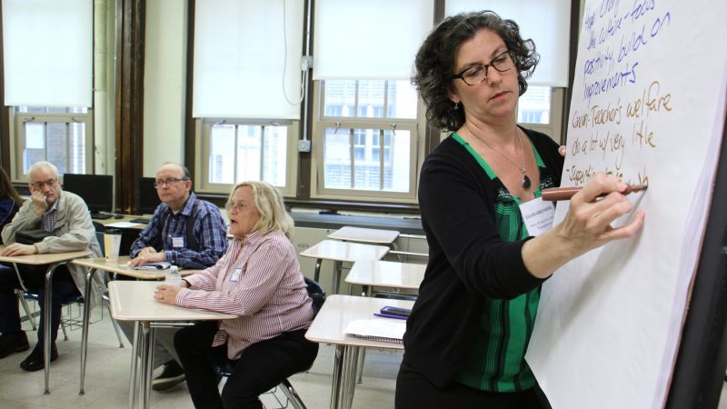 Facilitator Ellen Greenberg records the concerns of participants in a listening session for new school board members held at Dobbins High School. (Emma Lee/WHYY)