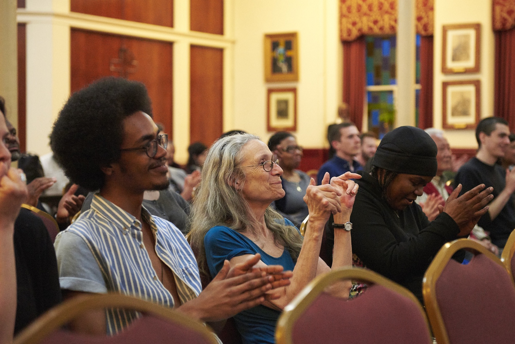 Audience members applaud performers at "Blessed are the Peacemakers."