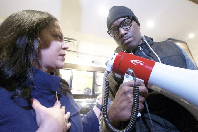 Camille Hymes, regional manager for Starbucks, speaks inside the coffee shop after hearing demands from the people gathered to protest Thursday's controversial arrest. (Bastiaan Slabbers for WHYY)