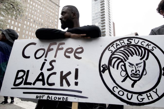 Jack Willis leans on a sign that reads 