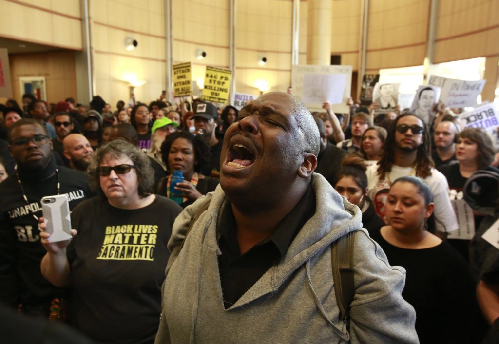 APTOPIX Sacramento Police Shooting Demonstrators gather outside the entrance to the Sacramento City Council chambers to protest the shooting death of Stephon Clark by Sacramento police, Tuesday, March 27, 2018, in Sacramento,