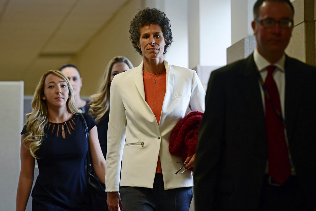 Andrea Constand, center, walks into a courtroom for Bill Cosby's sexual assault trial at the Montgomery County Courthouse, Friday, April 13, 2018, in Norristown, Pa. Constand, Bill Cosby's chief accuser, will take the witness stand on Friday.