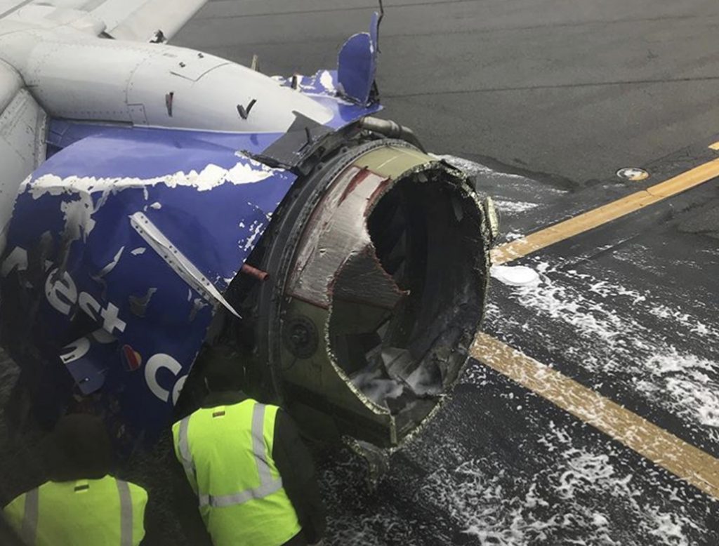 Southwest Airlines Emergency Landing The engine on a Southwest Airlines plane is inspected as it sits on the runway at the Philadelphia International Airport after it made an emergency landing in Philadelphia, Tuesday, April 17, 2018. (Amanda Bourman via AP)