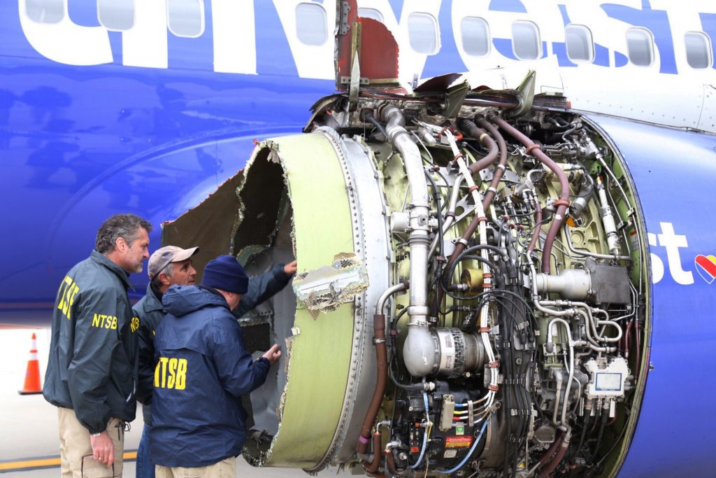 Southwest Airlines Emergency Landing National Transportation Safety Board investigators examine damage to the engine of the Southwest Airlines plane that made an emergency landing at Philadelphia International Airport in Philadelphia on Tuesday, April 17, 2018.