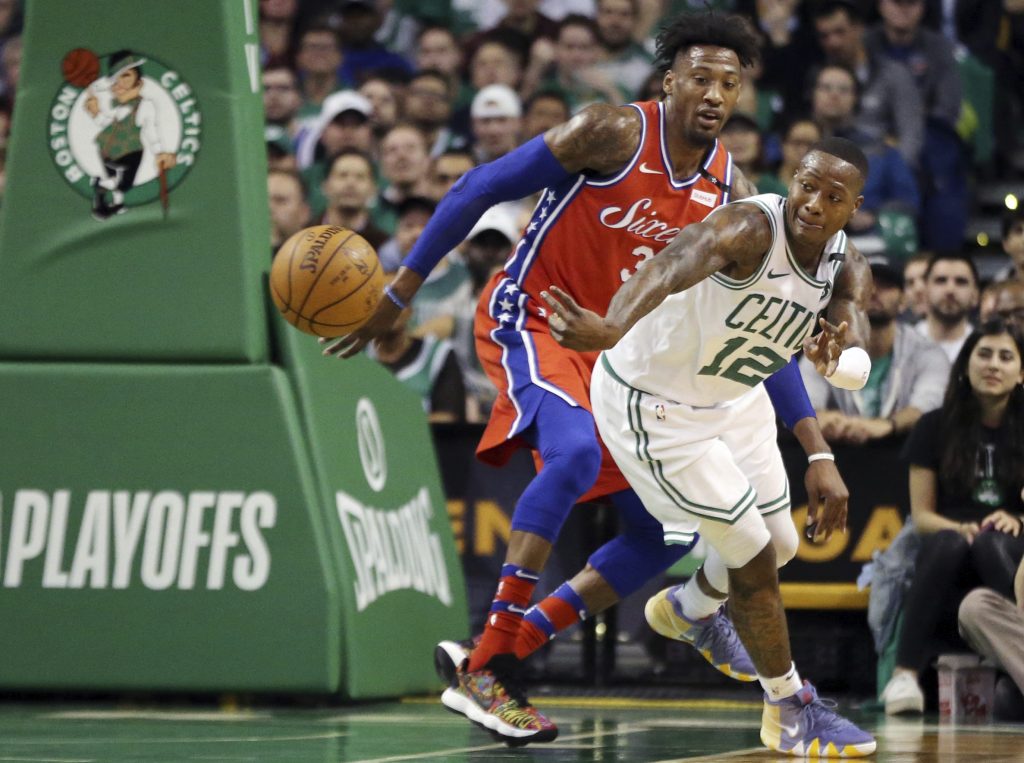 Terry Rozier, Robert Covington Boston Celtics guard Terry Rozier (12) passes the ball against the defense of Philadelphia 76ers forward Robert Covington (33) in the first quarter of Game 1 of an NBA basketball second-round playoff series, Monday, April 30, 2018, in Boston. (AP Photo/Elise Amendola)