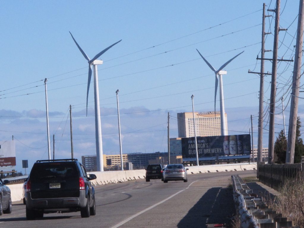 Wind Energy Cars drive past windmills on the grounds of a sewage treatment plant in Atlantic City, N.J. on Monday Jan. 4, 2016. (Wayne Parry/AP Photo)