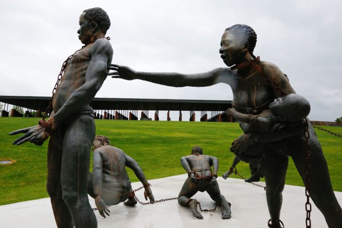 Part of a statue depicting chained people is on display at the National Memorial for Peace and Justice, a new memorial to honor thousands of people killed in racist lynchings, Sunday, April 22, 2018, in Montgomery, Ala. The national memorial aims to teach about America's past in hope of promoting understanding and healing. It's scheduled to open on Thursday. (Brynn Anderson/AP Photo)