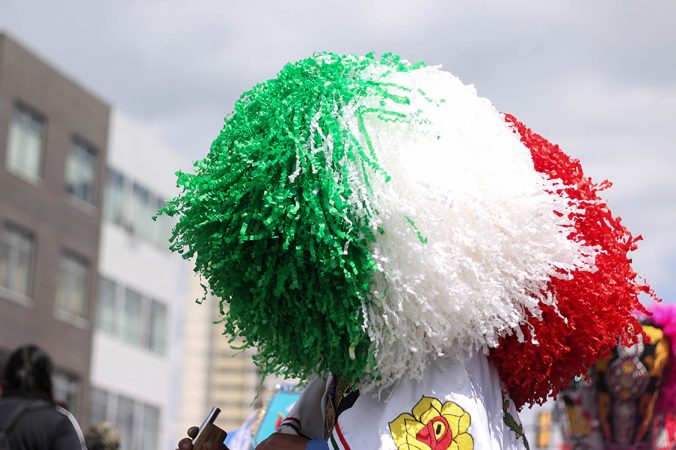 Carnavaleros celebrate in bearded masks and embroidered  Suits, draping themselves in the colors of the Mexican  flag.  (Angela Gervasi for WHYY)