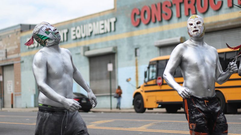 Slicked in silver body paint, performers march down Washington Avenue, cracking whips. The costume is said to symbolize the devil being let loose. (Angela Gervasi for WHYY)