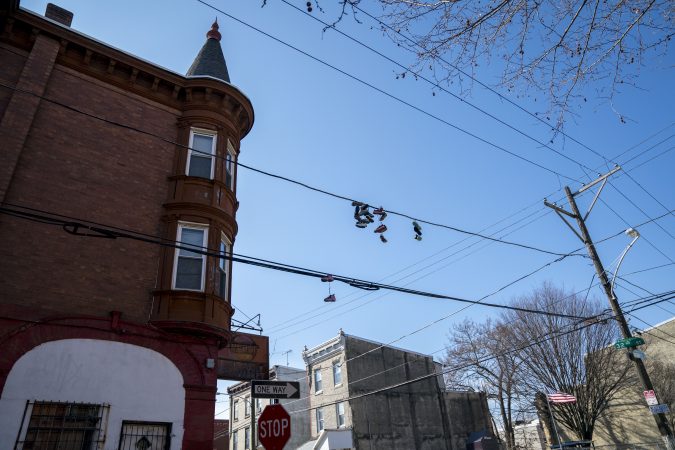 Sneakers hang from electrical wires in Strawberry Mansion. (Jessica Kourkounis/WHYY)