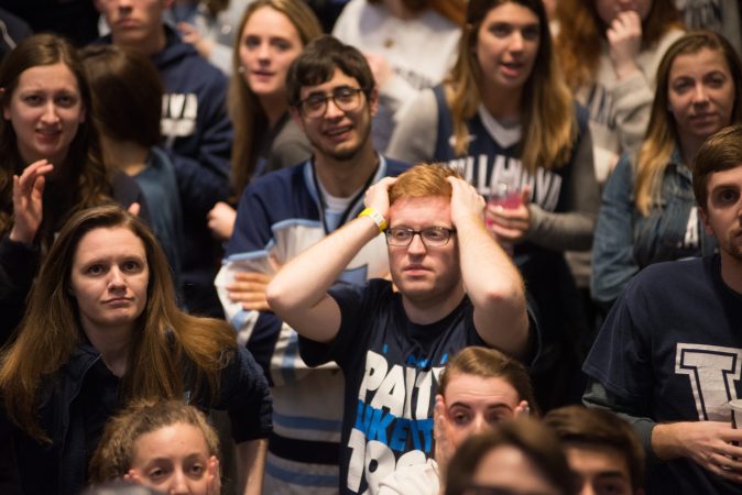Villanova students respond to a tough start for their team during the NCAA men's basketball championship game. (Branden Eastwood for WHYY)