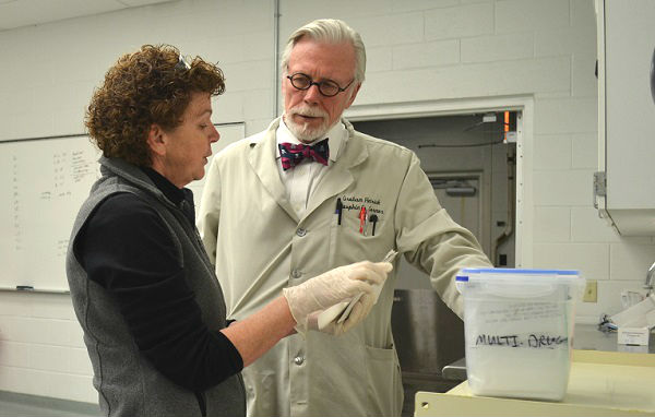 Dauphin County Coroner Graham Hetrick and Assistant Chief Deputy Coroner Lynn Choborda discuss blood test results. Like many Pennsylvania counties, Dauphin has had a steady increase in drug overdose deaths. (Brett Sholtis/Transforming Health)