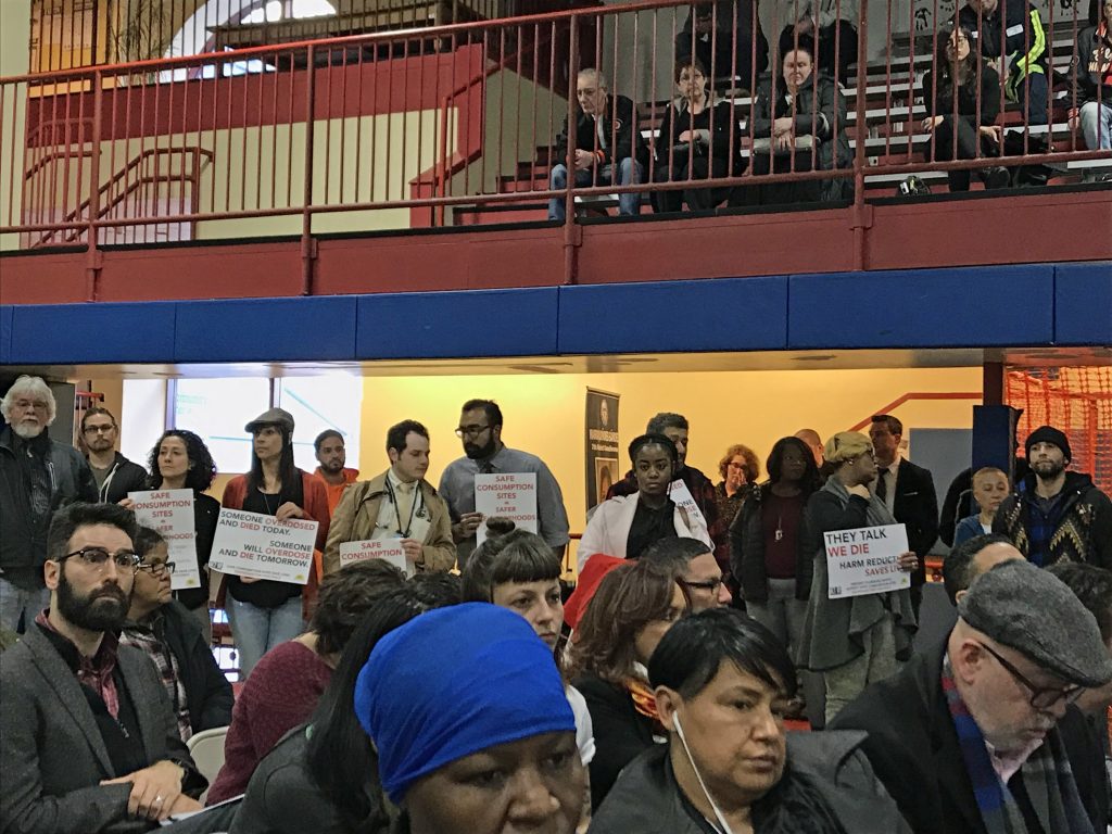 Demonstrators hold signs showing their support for a supervised injection facility for drug users in Philadelphia. (Joel Wolfram/WHYY)