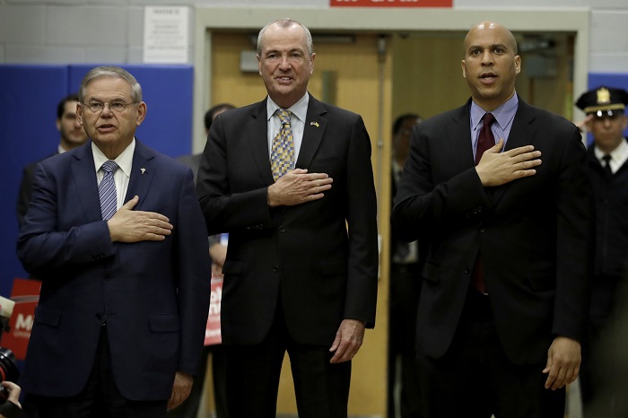 U.S. Sen. Bob Menendez, left, New Jersey Gov. Phil Murphy and Sen. Cory Booker attend an event kicking off Menendez's campaign for re-election at Union City High School, Wednesday, March 28, 2018, in Union City, N.J. (AP Photo/Julio Cortez)
