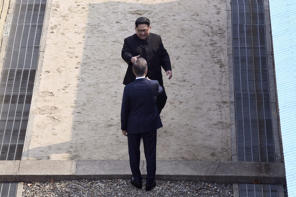 Kim approaches to shake hands with Moon at the border village of Panmunjom in the Demilitarized Zone, South Korea, on Friday. Hand out, North Korean leader Kim Jong Un approaches South Korean President Moon Jae-in at the border village of Panmunjom in the Demilitarized Zone on Friday. (Korea Summit Press Pool via AP)